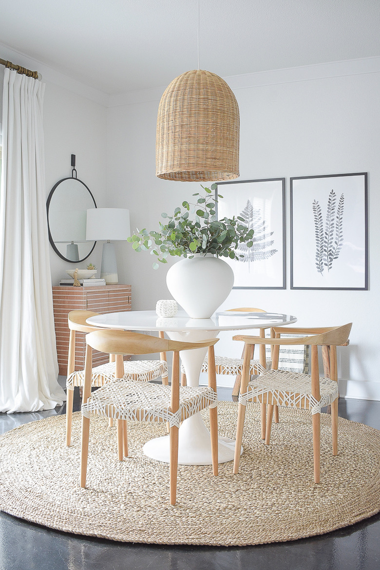 dining room lighting idea with woven bell pendant over round table with round rug