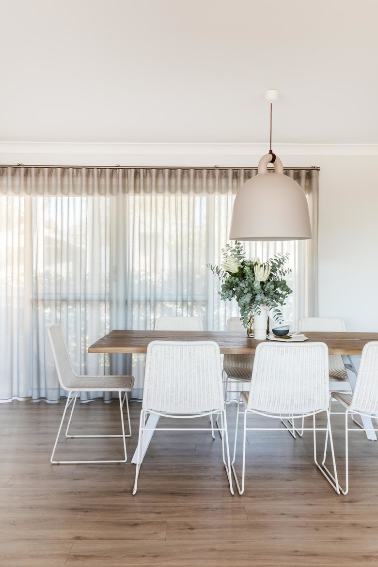 white dining room lighting idea with oversize minimal pendant