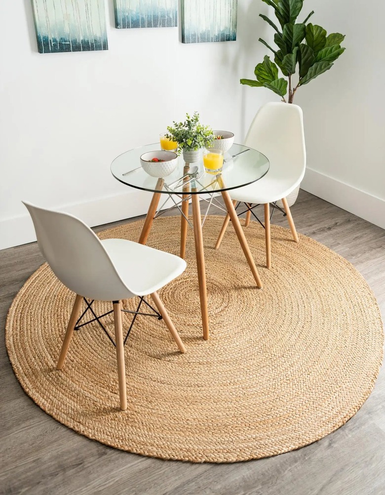 round jute rug under clear glass table and chairs