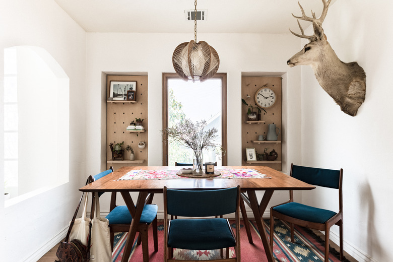 Dining room with pegboard shelves for storage