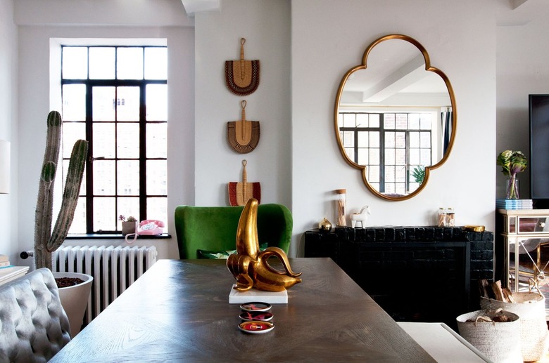 a whimsical gilded banana sculpture forms a centerpiece for a table