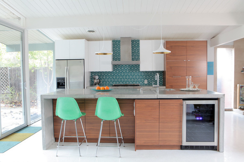 Midcentury-inspired kitchen with DIY waterfall concrete island and wood cabinets