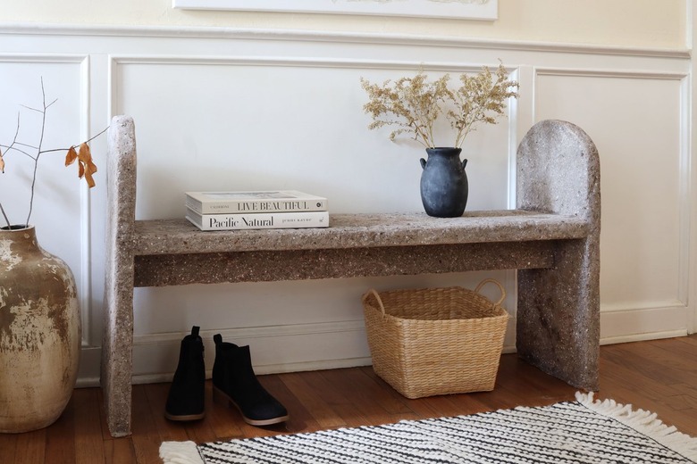 DIY limestone hypertufa bench in entryway with shoes and basket