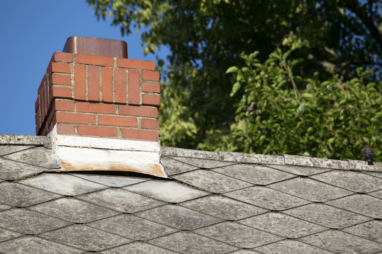 Damaged and old roofing shingles and gutter system on a house