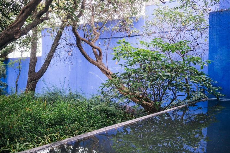 Mid-Century blue building with pond surrounded by trees