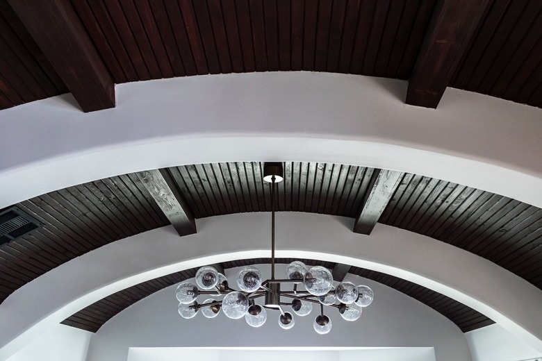 Wood ceiling arches and a multi globe chandelier