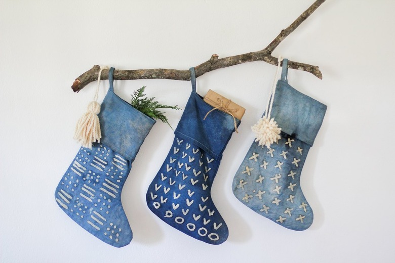 DIY Christmas decorations with stockings of varying indigo hues on a decorative branch