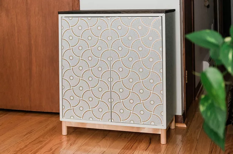 Cabinet with modern wallpaper.