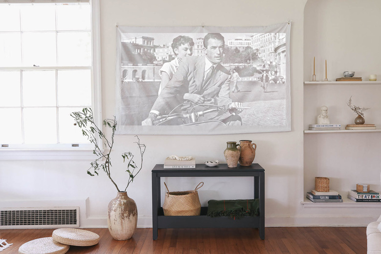 DIY portable projector screen hanging on wall in living room above console table