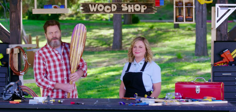 two people standing in a space with a sign that reads wood shop