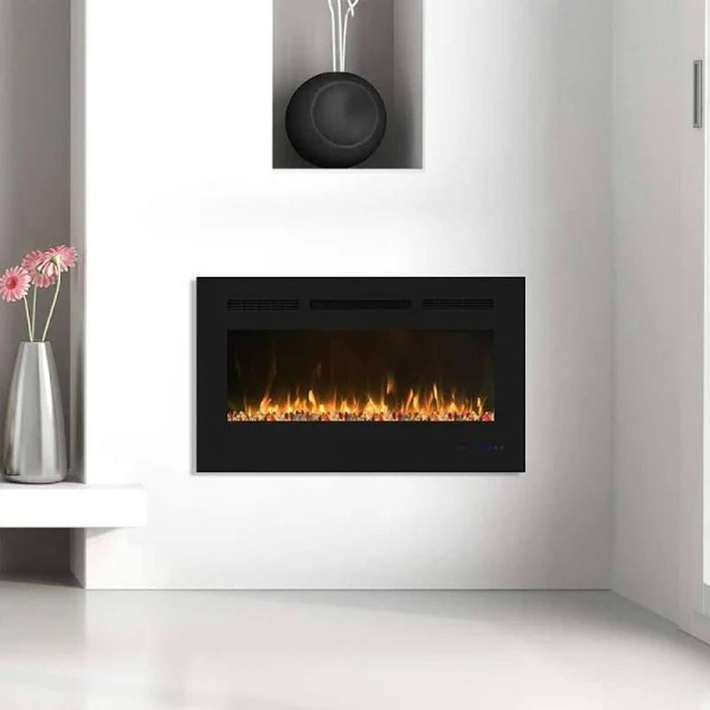 A white electric fireplace insert on a white wall