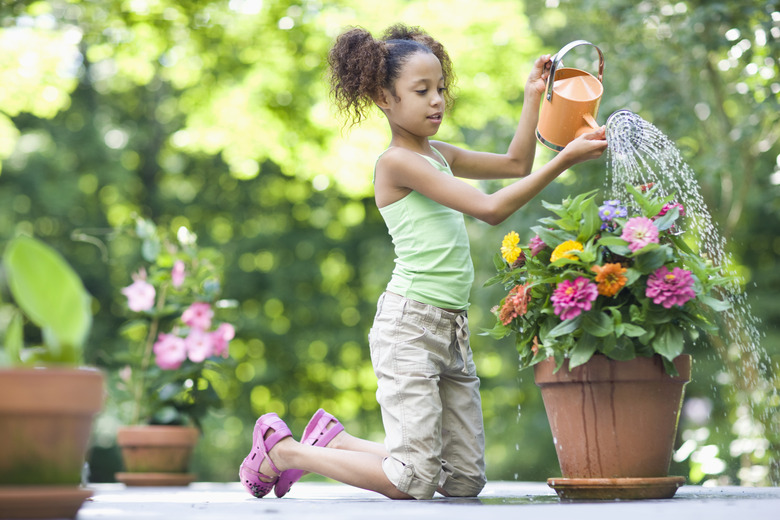 Girl Watering Potted Flowers