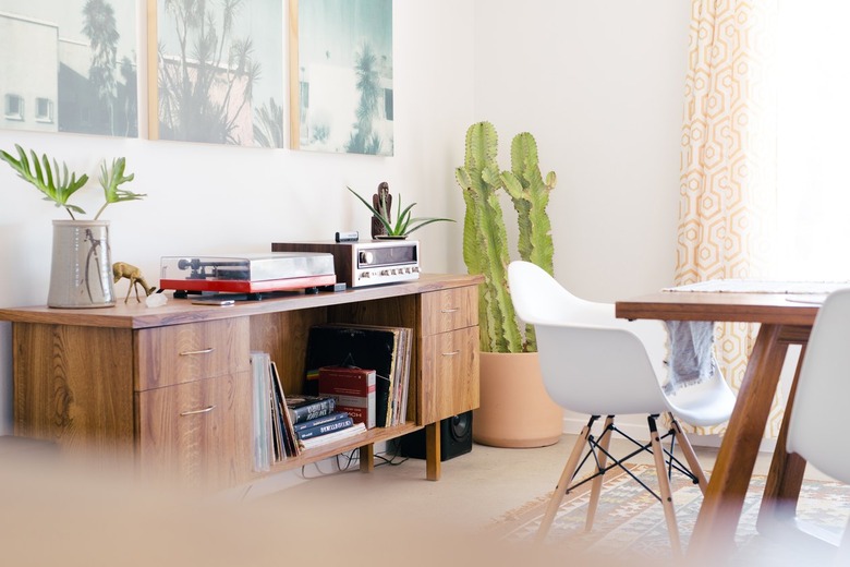 vintage audio equipment, books, and records in a mid-century console