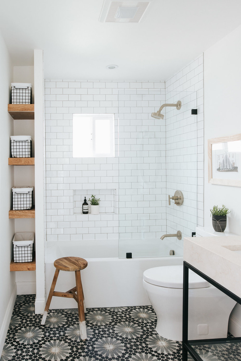 monochrome bathroom with small bathtub and storage