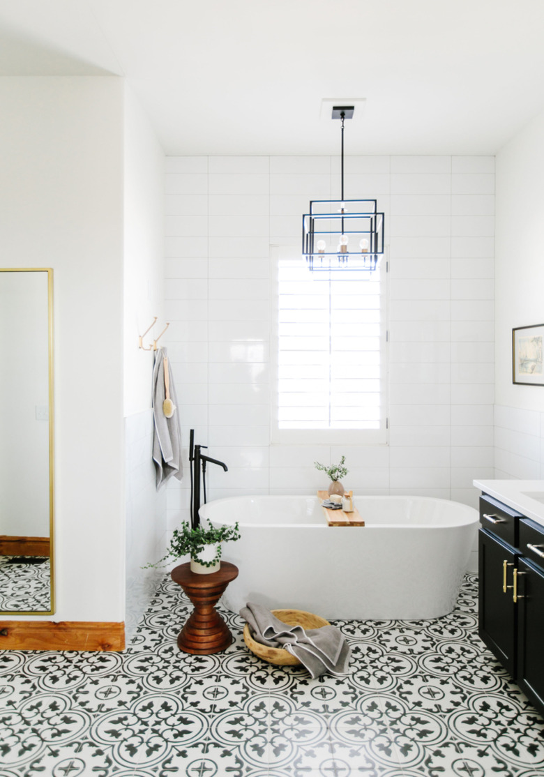 modern bathroom with small bathtub and patterned floor tile