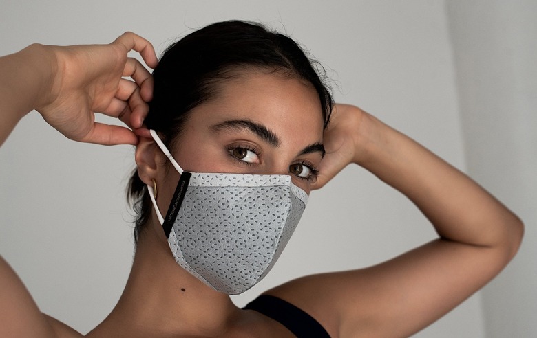 woman putting on KILLSPENCER SST Face Mask