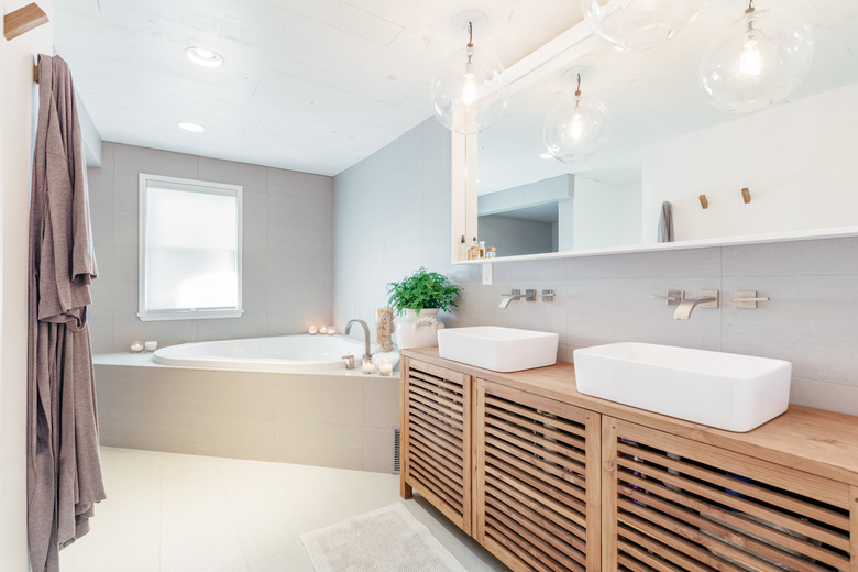 modern bathroom with single-panel mirror over double vanity