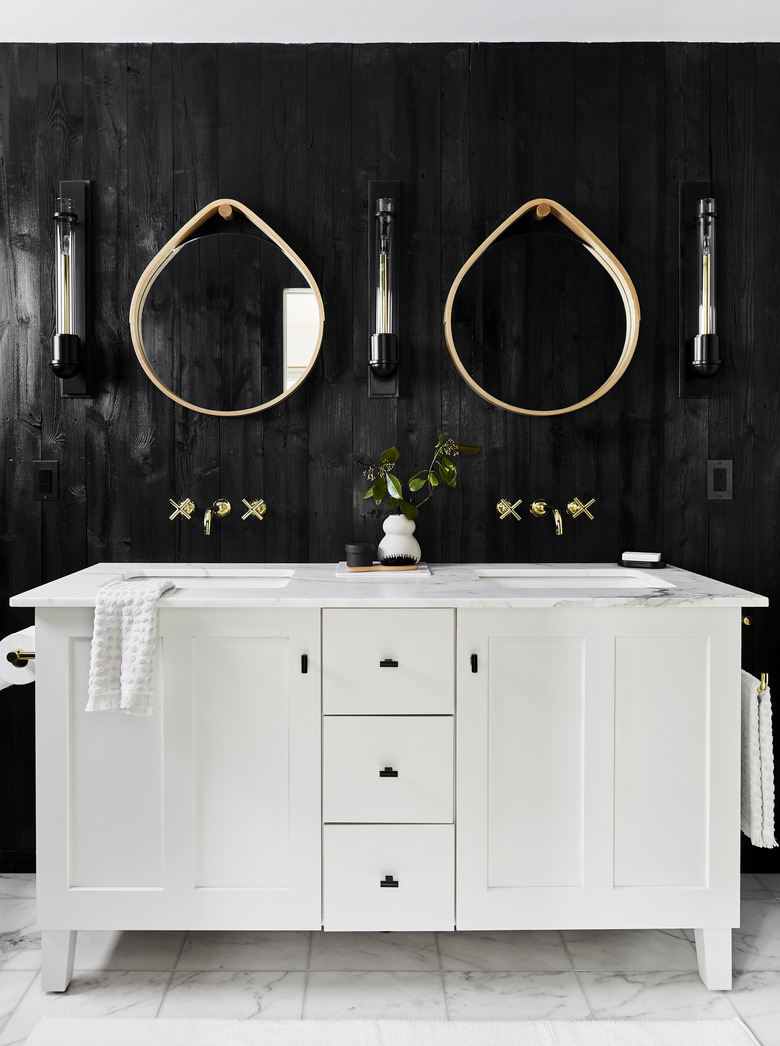 modern bathroom with teardrop mirrors over double vanity