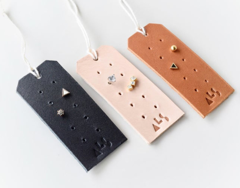 Earring Storage with Black, pink and brown leather tags with stud earrings.