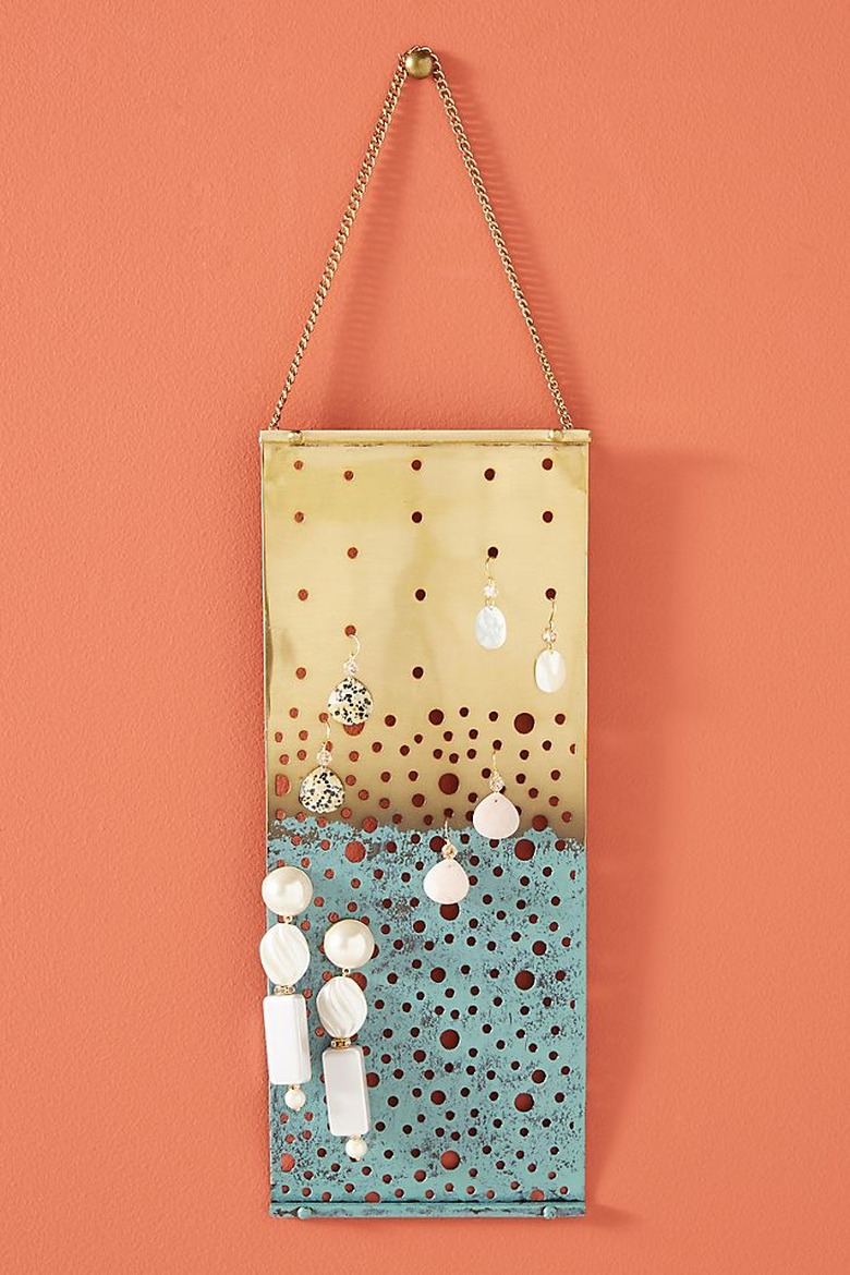 Earring Storage with Gold and turquoise hanging earring organizer with earrings.