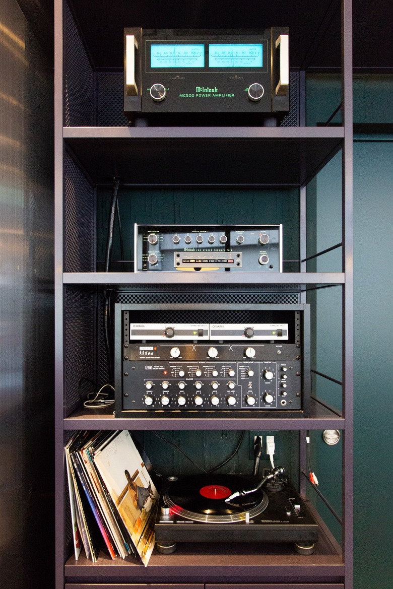 Black shelves with record player and amps