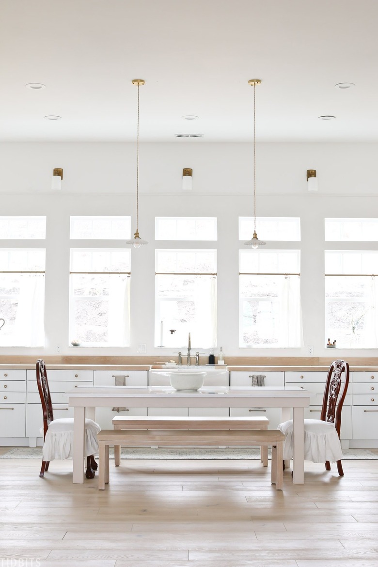 white eat-in kitchen with dining table in kitchen and pendant lights