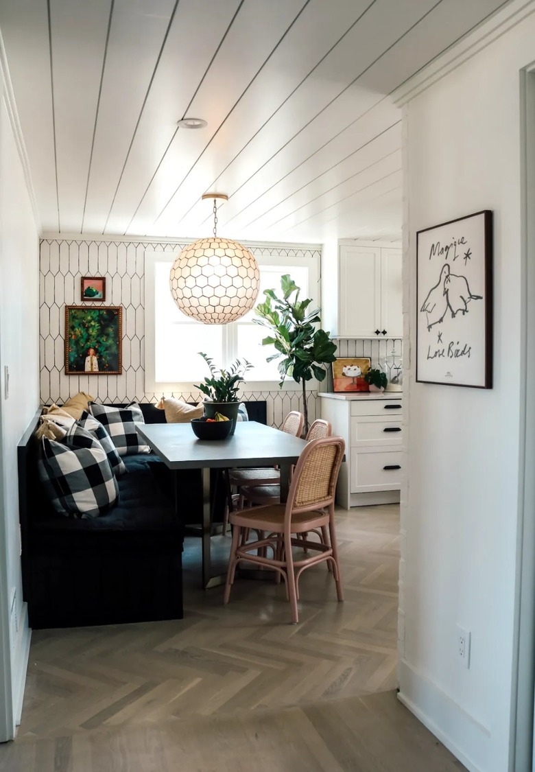 white eat-in kitchen with cozy banquette and throw pillows