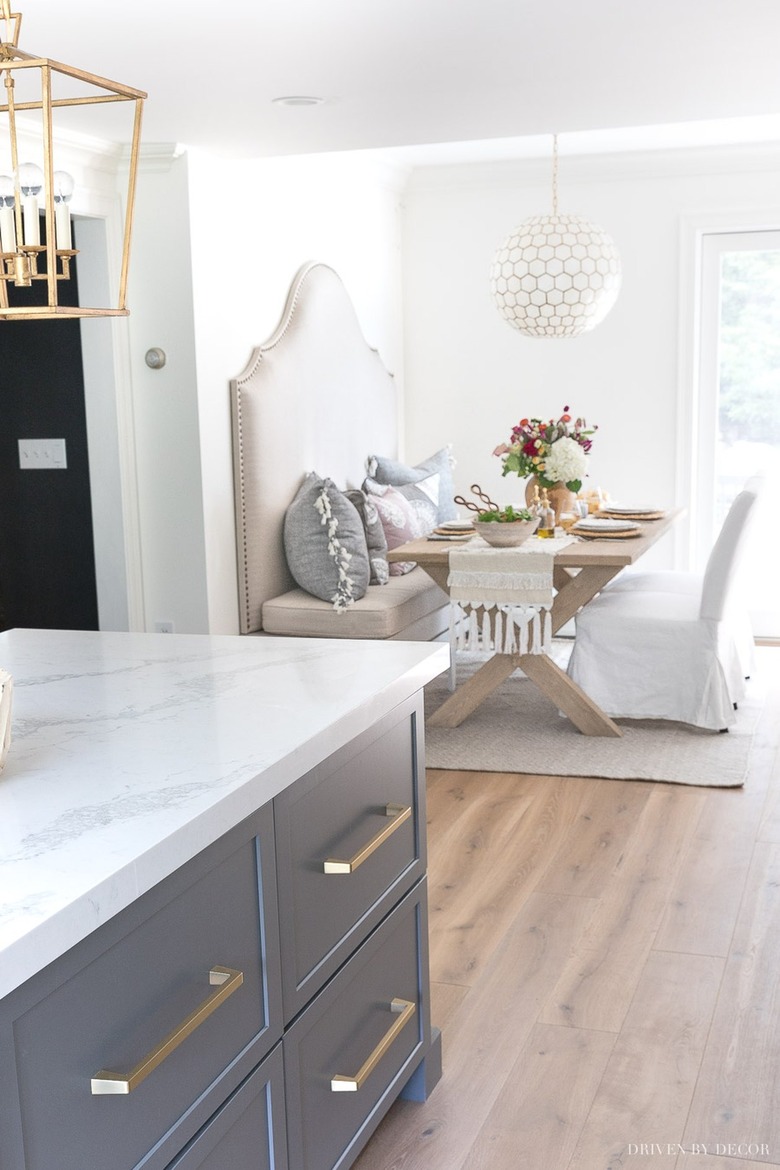 blue eat-in kitchen with upholstered bench in banquette