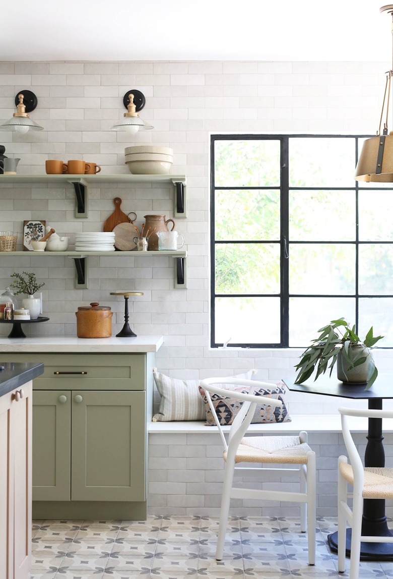 sage eat-in kitchen with white subway tile wall