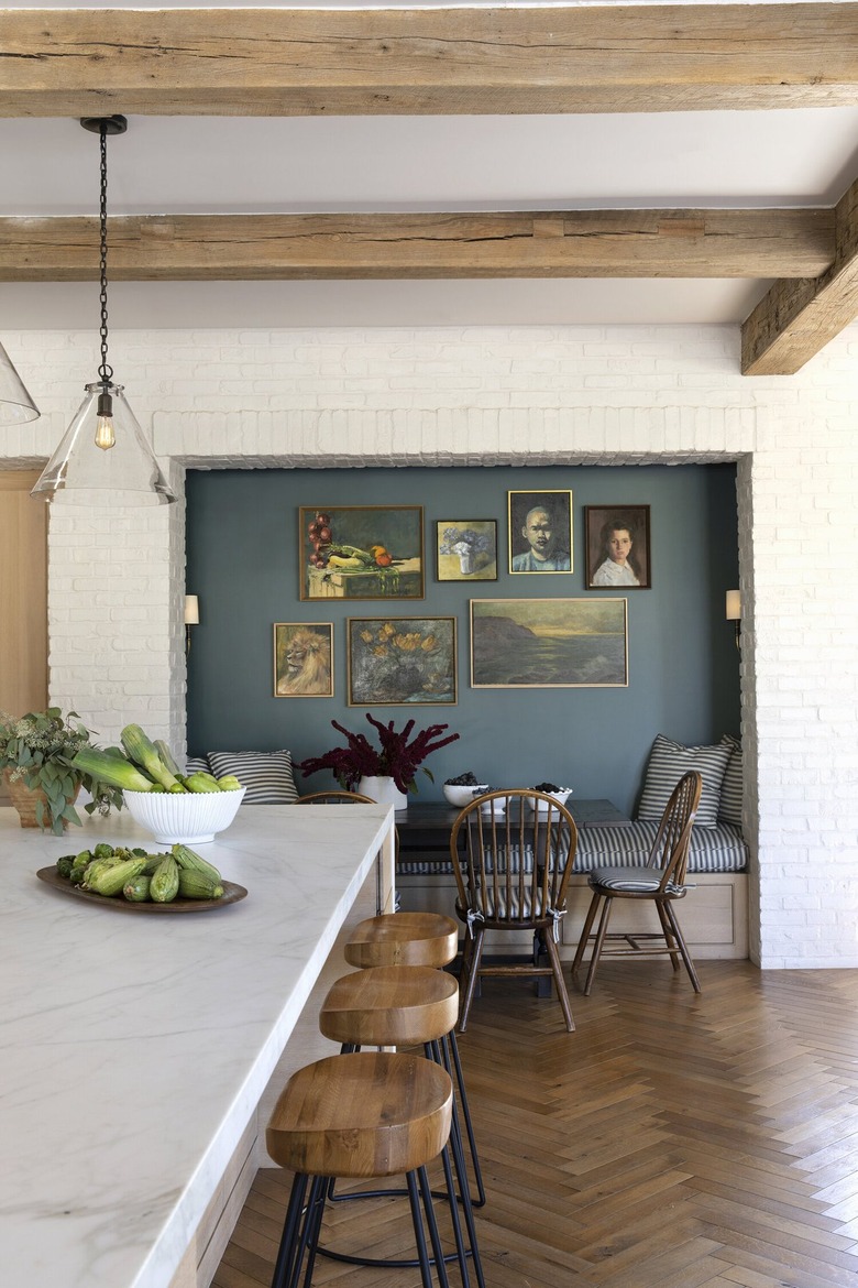 white eat-in kitchen with banquette and blue accent wall