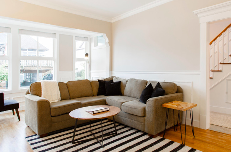 living room space in Craftsman home with neutral couch and wood side tables