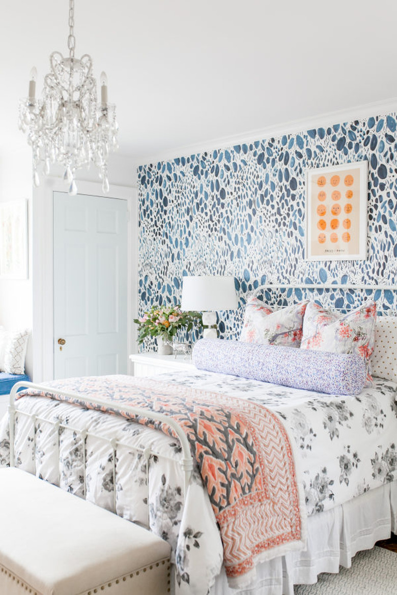 country bedroom idea with modern bedroom with floral bed linen and patterned wallpaper