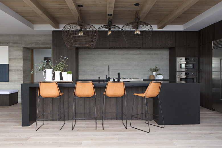 espresso kitchen island with trio of wire pendants hanging above