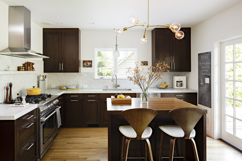 espresso kitchen island in midcentury space with dark cabinets