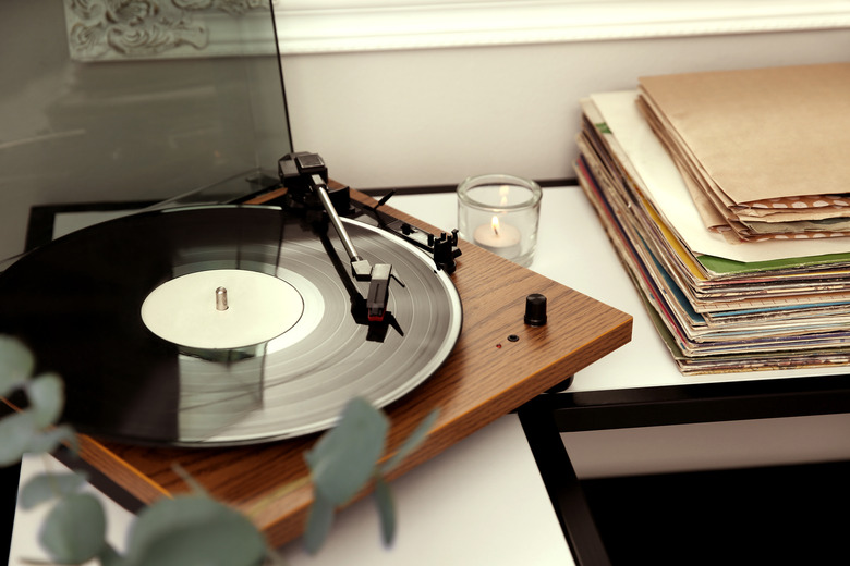 Stylish turntable with vinyl record on table indoors