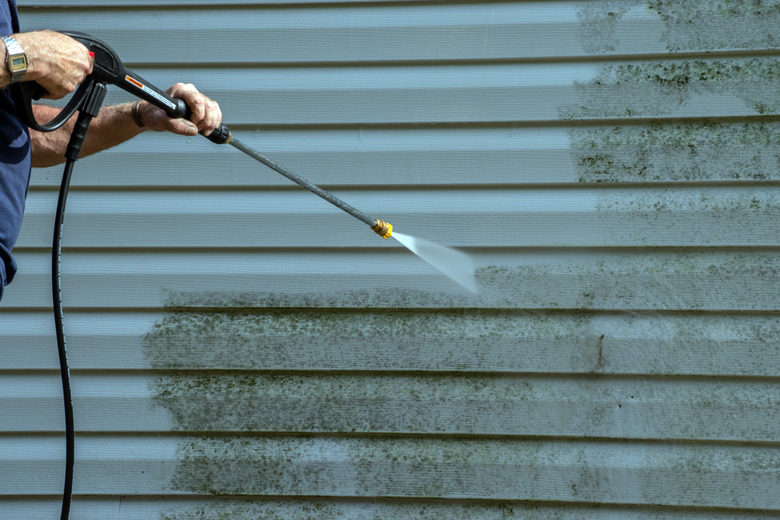 Power washing in progress on the north outer wall.