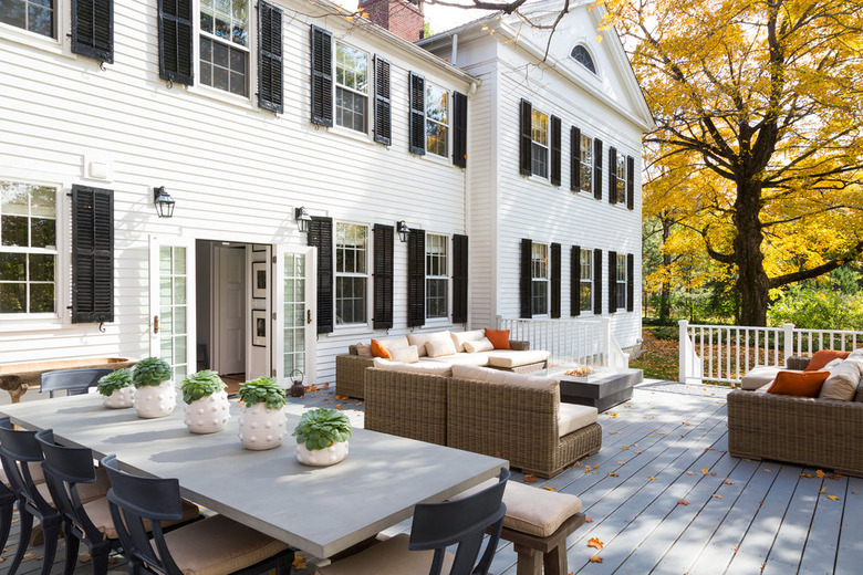 white French exterior back door on house with board and batten and black shutters