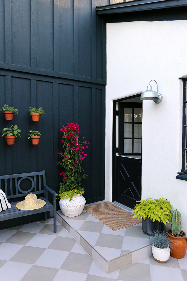 black Dutch exterior back door on white house with black siding