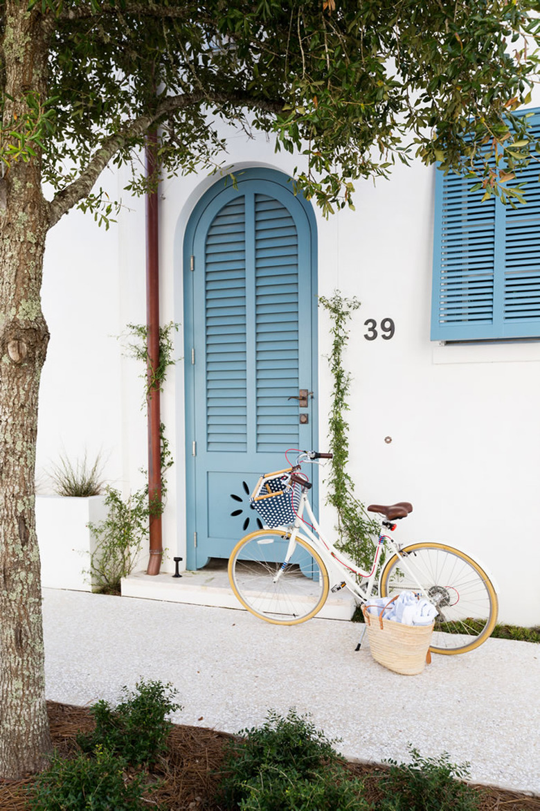 exterior door trim on mediterranean house with blue front door and trim