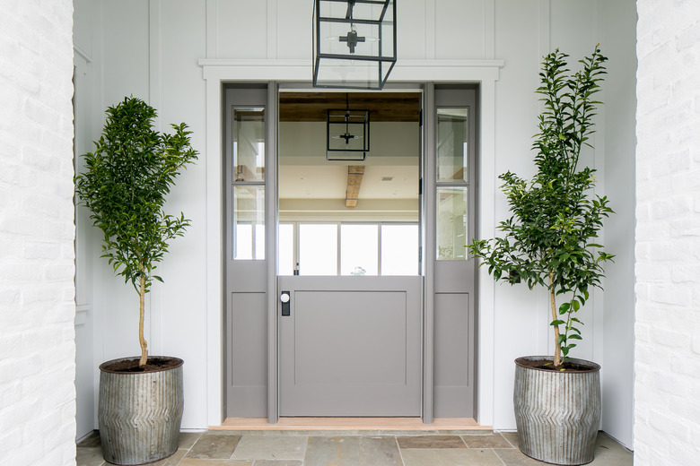 exterior door trim on gray front door with statement white wooden trim