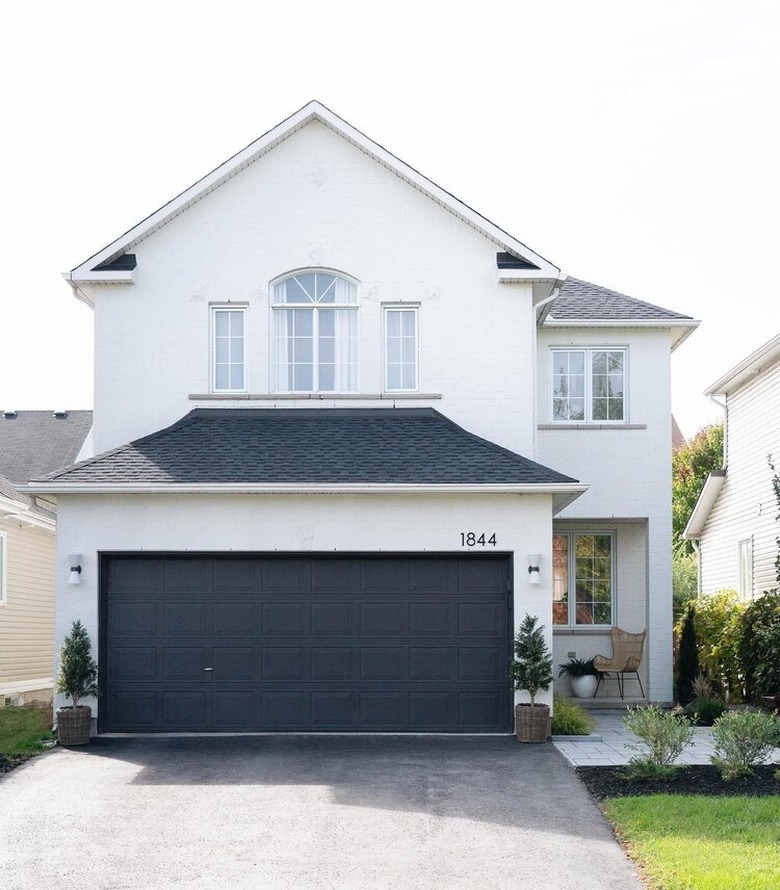 Modern sconce exterior house lights next to garage door