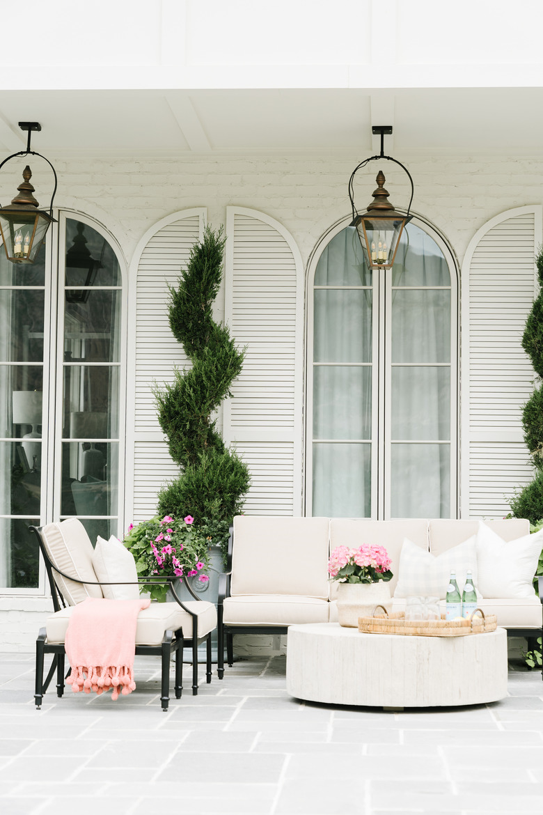 Tall exterior house shutters with white exterior and patio