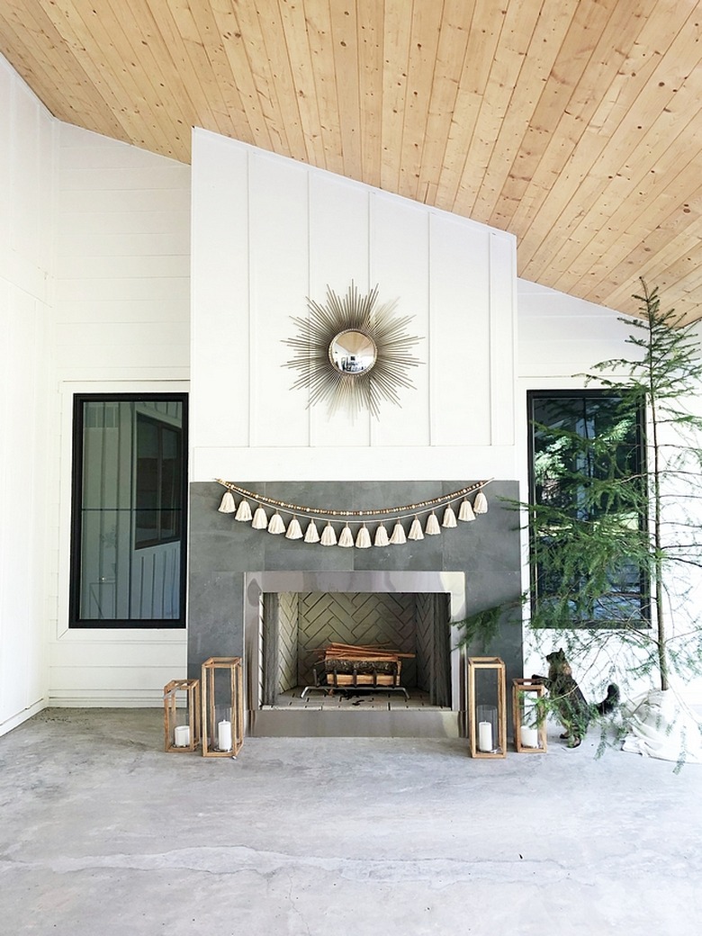 White exterior paneling on modern outdoor fireplace