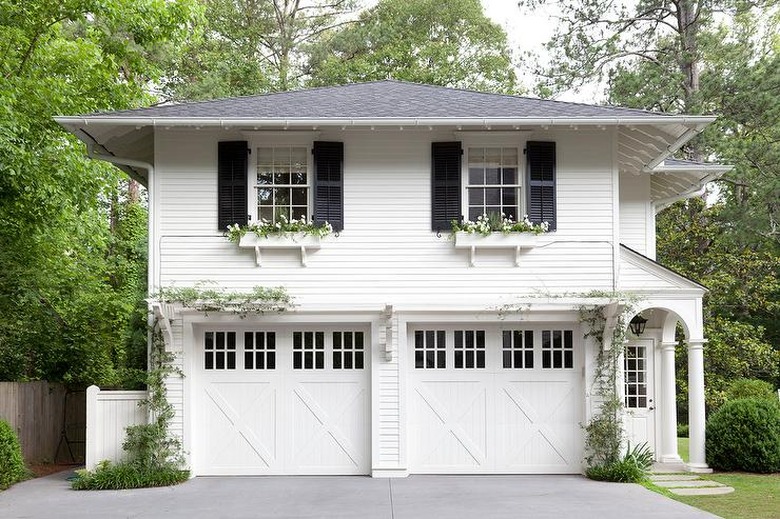 traditional home with white exterior siding ideas and black shutters