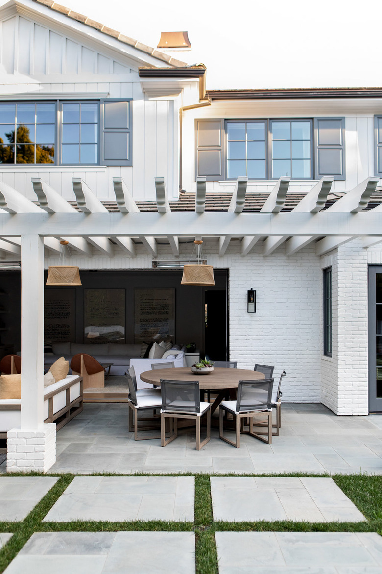 White house with gray exterior window trim and outdoor seating area