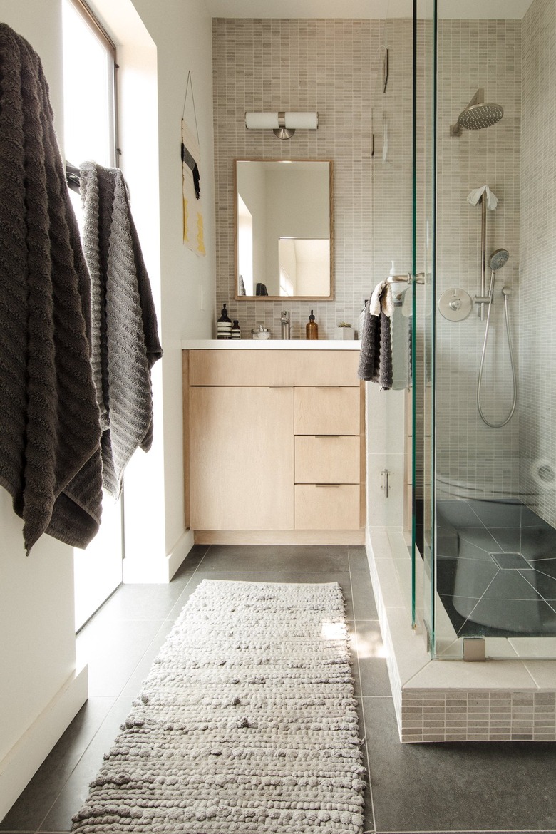 Neutral bathroom with large shower, smaller vanity.