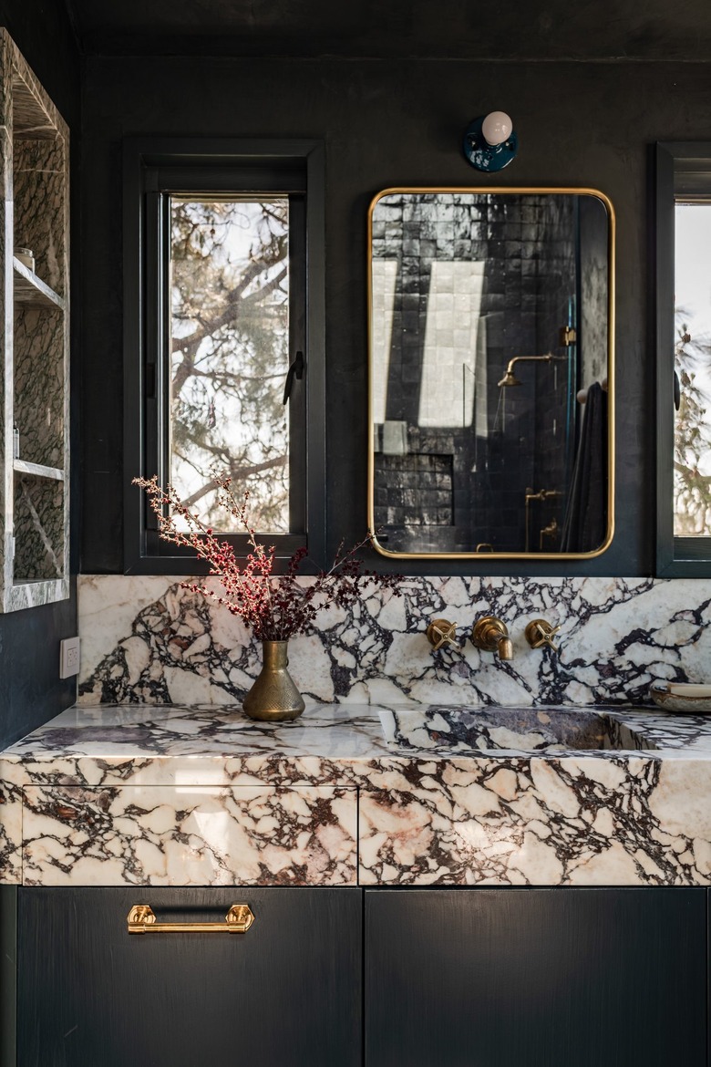 black primary bathroom with marble sink and countertop