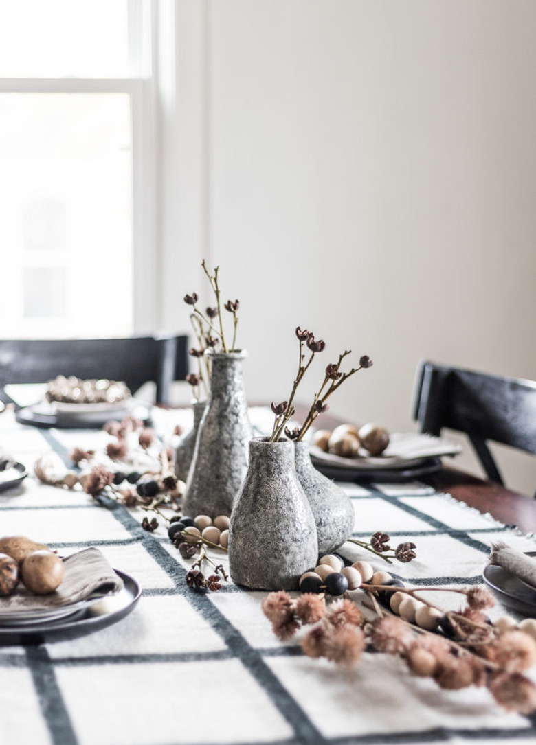 Gray vase fall centerpieces with dried florals and plaid tablecloth