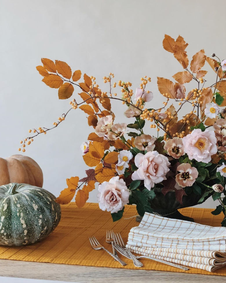 pink rose fall flower arrangement with dried leaves and berries