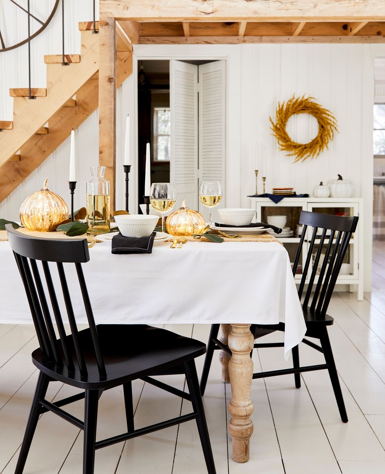 metallic fall pumpkins on table in Scandi dining room